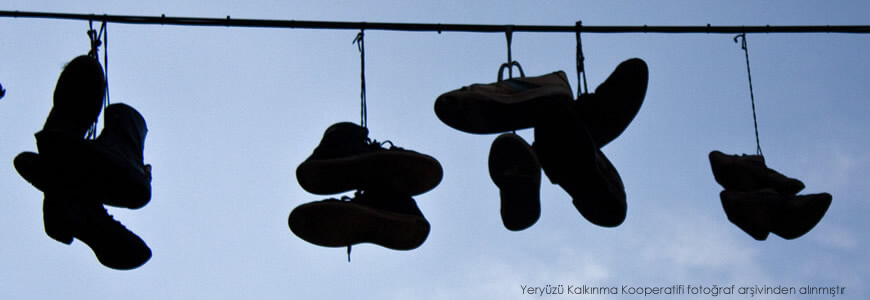 Hollanda'nın Amsterdam kentinde çekilmiş fotoğrafta elektrik tellerine asılı ayakkabılar bulunuyor. Elektrik tellerine asılı ayakkabıların, insanların kentsel yaşamın sıradanlığından kaçabileceği kamusal alanları işaret etmek için kullanılan bir figür olduğu düşünülmektedir